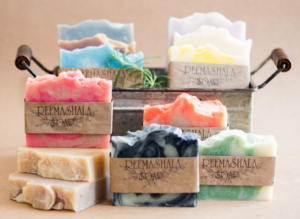 Various soap bars in and around a metal basket.